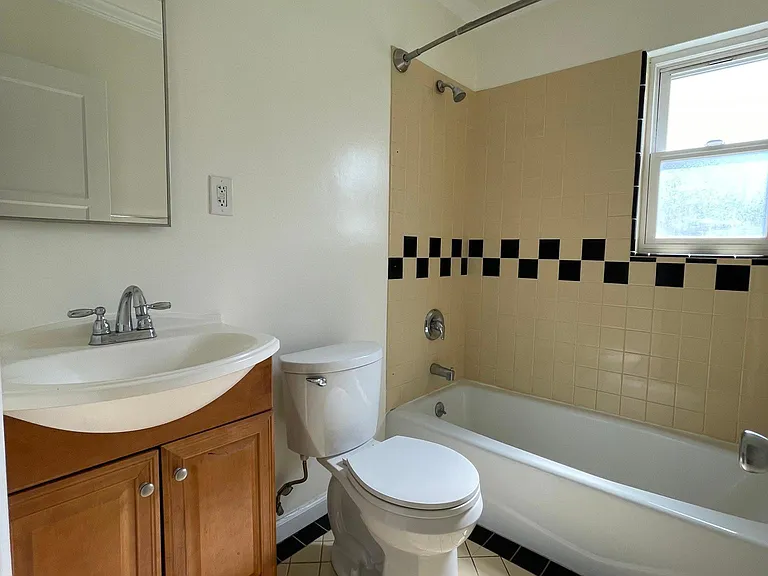 Custom tiled bath with tub and shower combo.