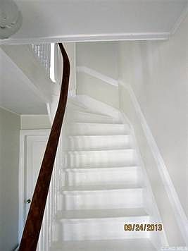 Original banister and wall molding on beautiful curved stairway