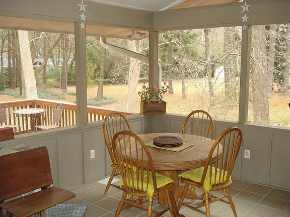 Screened-in back porch is great for eating outdoors