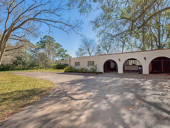 The home features a three car carport and a fantastic circular driveway.