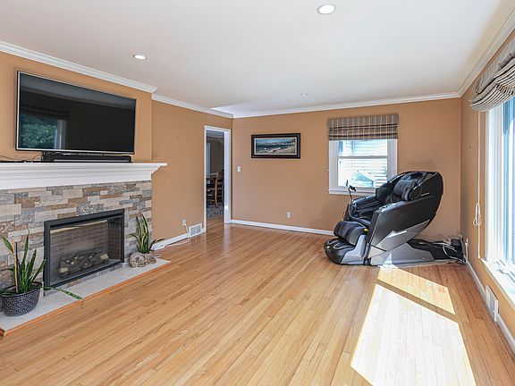 Living room includes 55 inch smart tv mounted above electric fireplace that can add ambience or also bring extra warmth on those chilly winter nights.