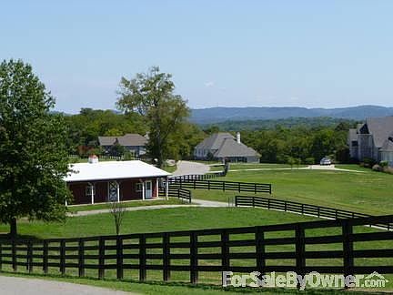 View from near community entrance.
						:
						Beautiful four-rail horse fencing throughout community!
