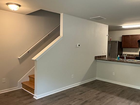 Living room with view of kitchen and stair