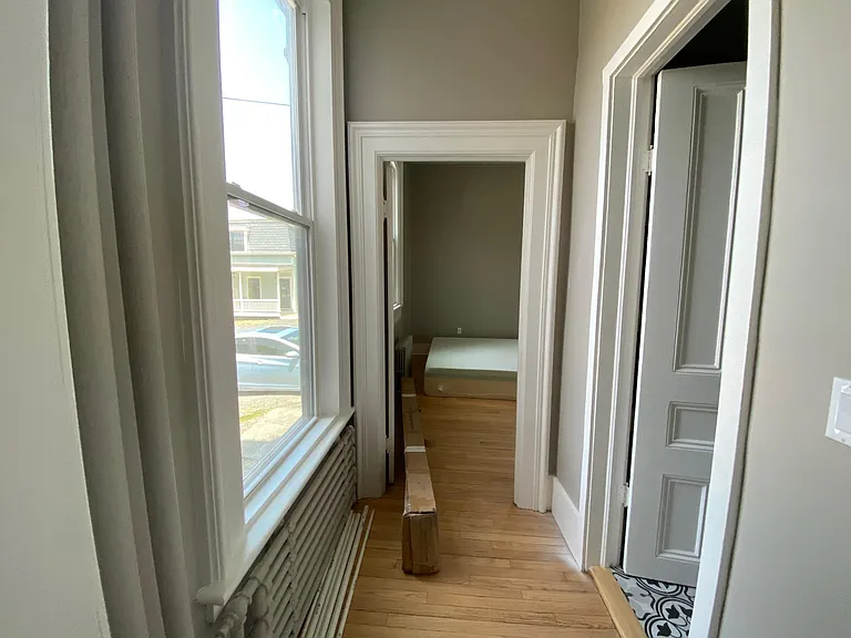 hallway from kitchen to bedroom, bathroom door on right