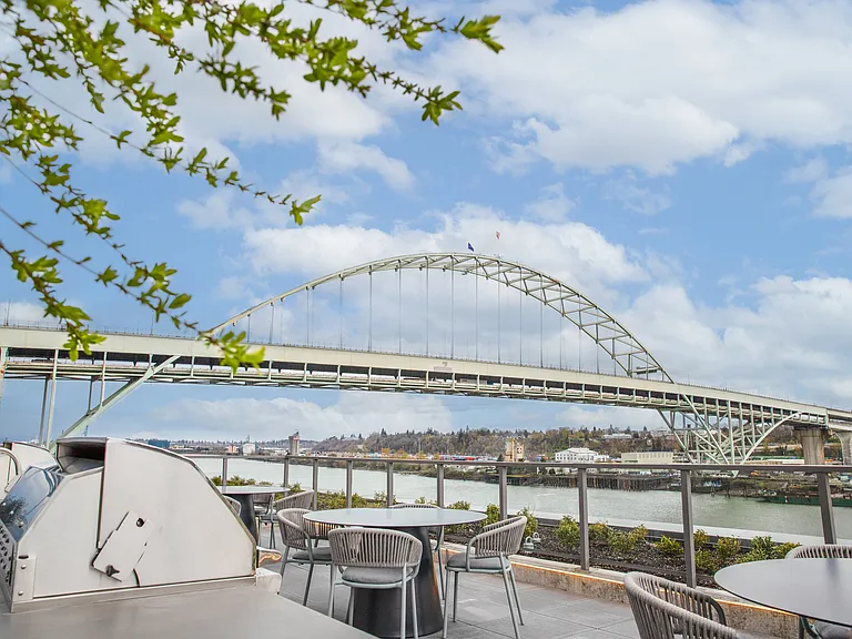 Panoramic rooftop with lounge seating, BBQs, and views of the Fremont Bridge