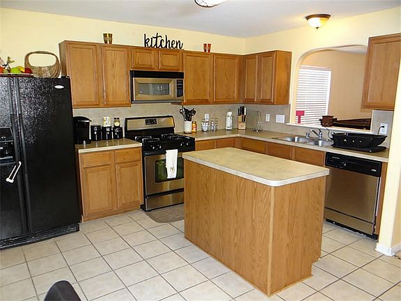Enjoying cooking in your very own island kitchen.   Nice and open floor plan so the chef in the family can watch the food cooking on the stove while he/she is talking to friends and family either in the breakfast area or the dining room.