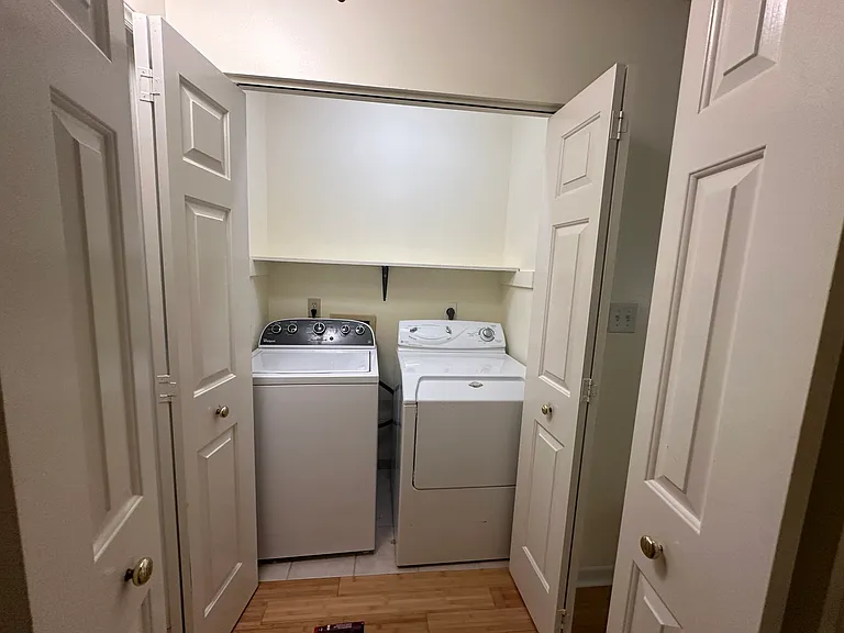 The laundry closet is in the upstairs hallway across from a large walk-in linen closet