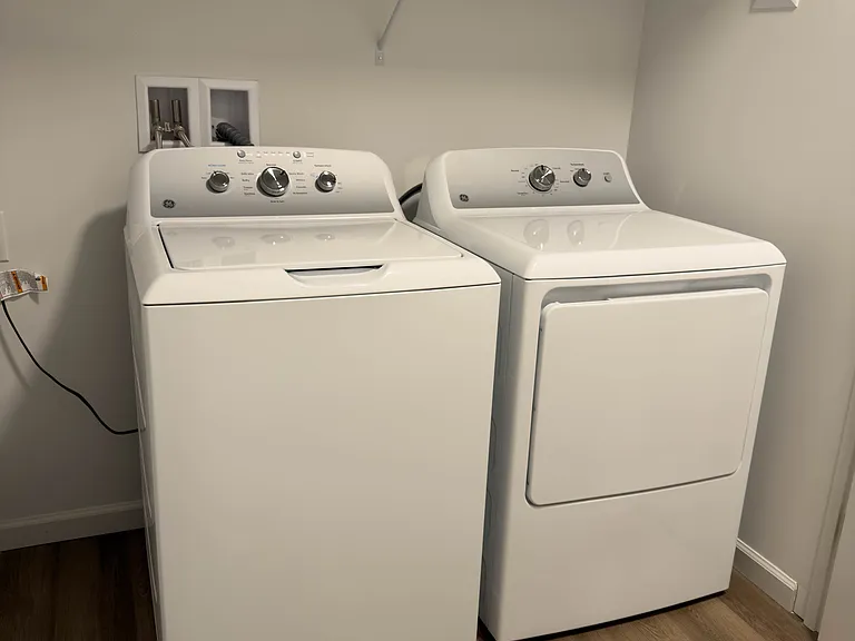 A large laundry room offers plenty of extra storage space