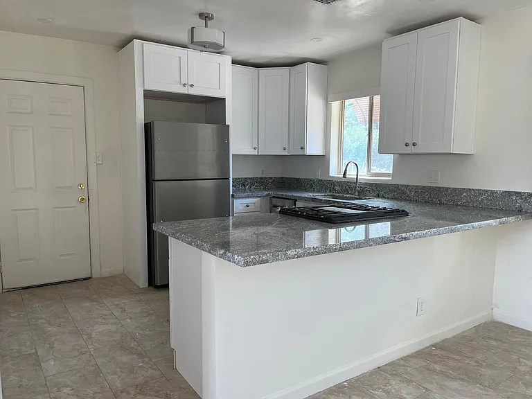 New Kitchen features with granite countertop, high end cabinets, and stainless-steel appliances.