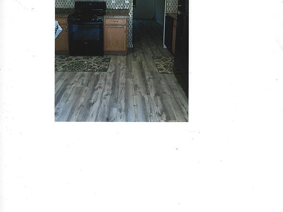 Eat-in kitchen with access to patio, new flooring and new appliances.