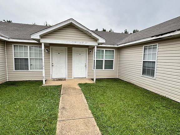 Large open yard, with a walkway to the parking lot.