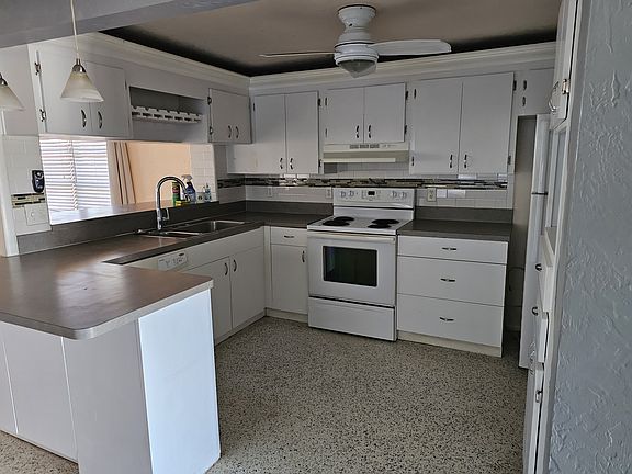 Kitchen has plenty of storage, a wine rack, built-in pantry with wire pullouts holds cans and boxes.