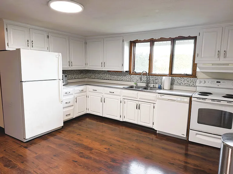 Large bright eat-in kitchen with laminate flooring