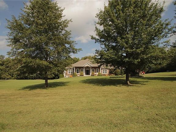 Surrounded by pin oak trees and manicured 3 acre lawn.