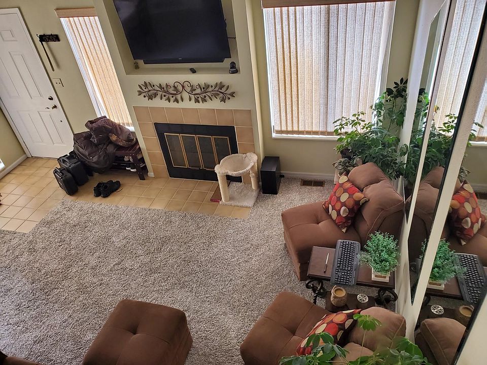 Very open floor plan, nearly new carpet, lots of light, fireplace. Dining room is to the left in this photo. Notice the soaring ceilings.