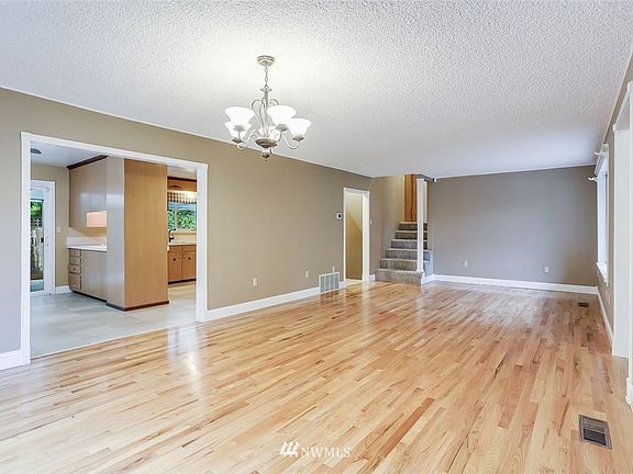 Hardwoods welcome you into this open great room.  From this view, the entry into the house is on the right. Plenty of room to set this room up as formal dining and living.