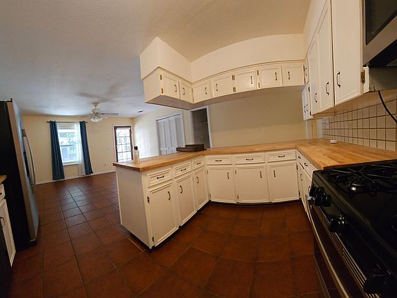 Beautoful fireplace and lots of windows in family room.