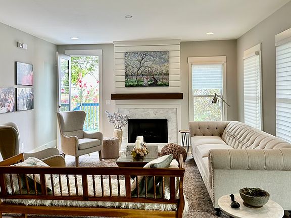 Living Room - Main Level with a gas fireplace. The door leads to one of the two decks