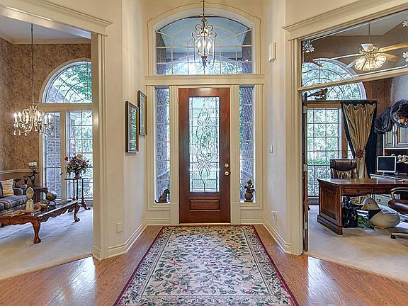 Lead glass door greets your guests. Office with french doors and formal dining.