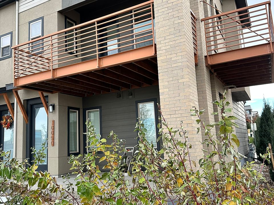 Modern, airy, and solar-powered end-unit townhouse with a large deck wrapping the northwest corner.