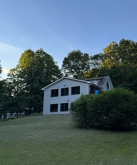 view from the meadow up at the house