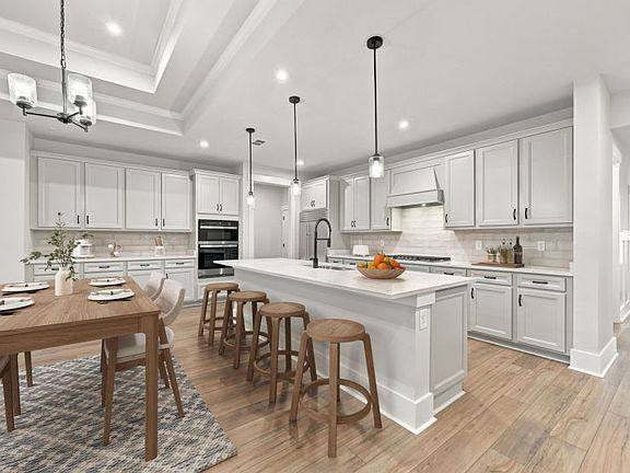 Bright open kitchen and family room with large island and connected seating space.