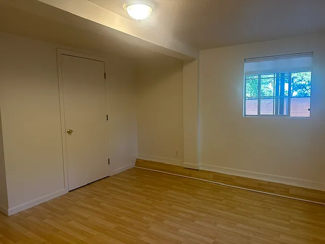 bedroom looking at closet and private enclosed back patio