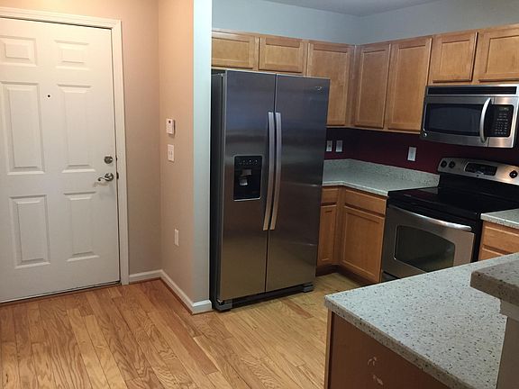 Kitchen with new refrigerator. Front entry.