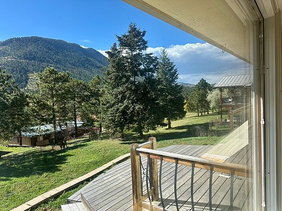 Deck and glorious west-facing views, as seen through the large living room picture window.