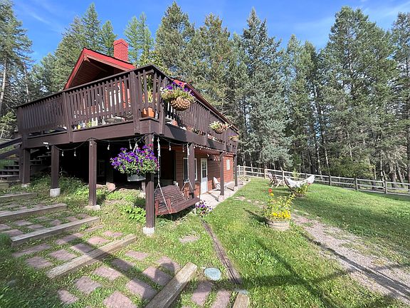 Fire Pit, hanging swing, and fenced yard.