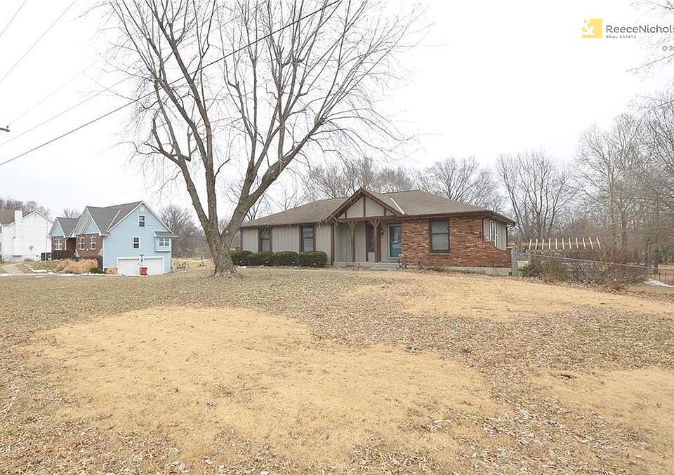 Partial brick front and large shade tree