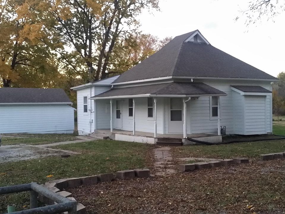This is a corner house with extra parking on Fourth Street and Hammond Street. This shows the detached garage and front entrance of the house.