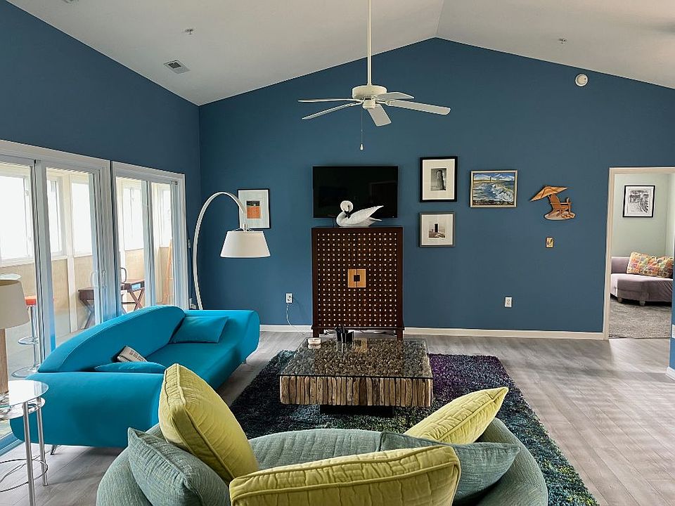 Living room with attached lanai and ceiling fan.