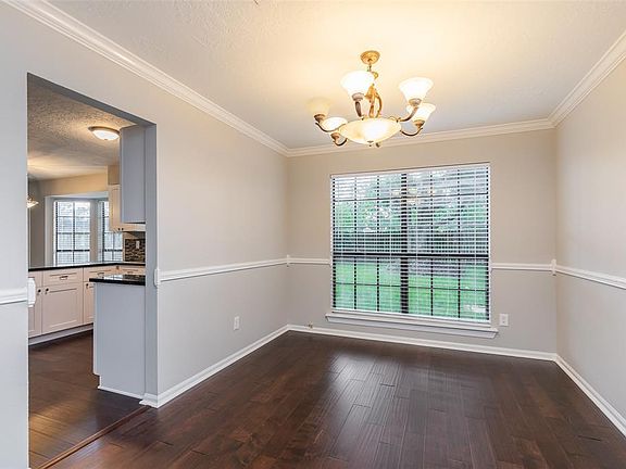 This dining room can seat a crowd and has lots of natural lighting.