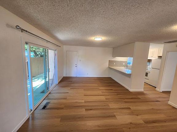 Roomy family room / nook features an eating bar, opens onto patio, and just a few steps from the kitchen.