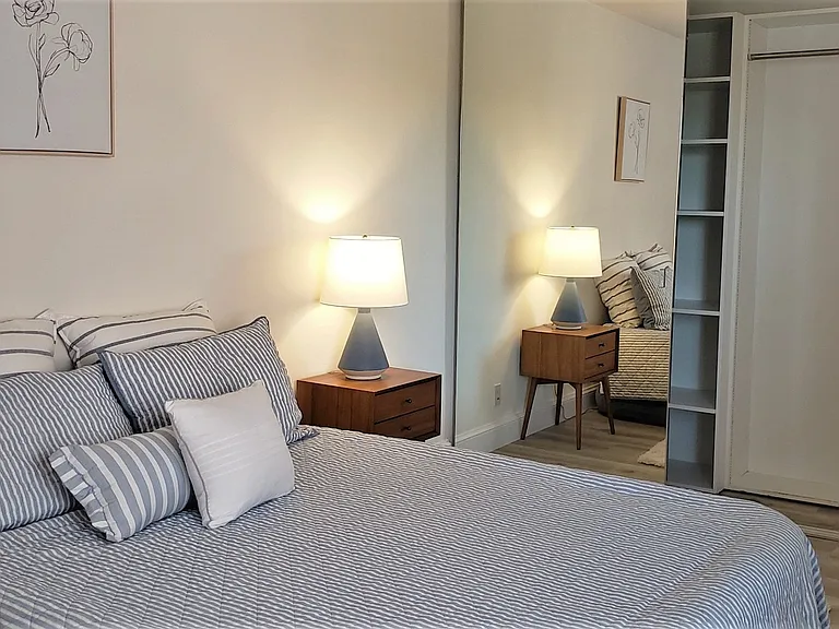 302/ 802 Bedroom with mirrored closet doors and shelves in closet