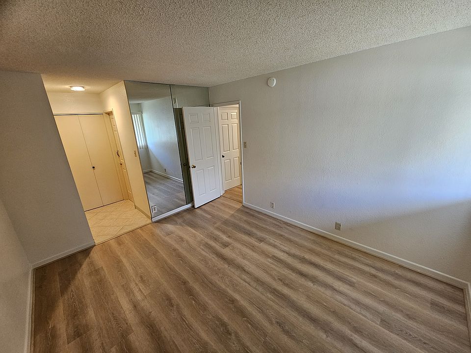 Large master bedroom with full length mirror and two closets.