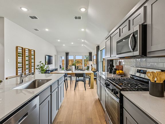 Kitchen in the Turquoise home plan by Trophy Signature Homes - REPRESENTATIVE PHOTO