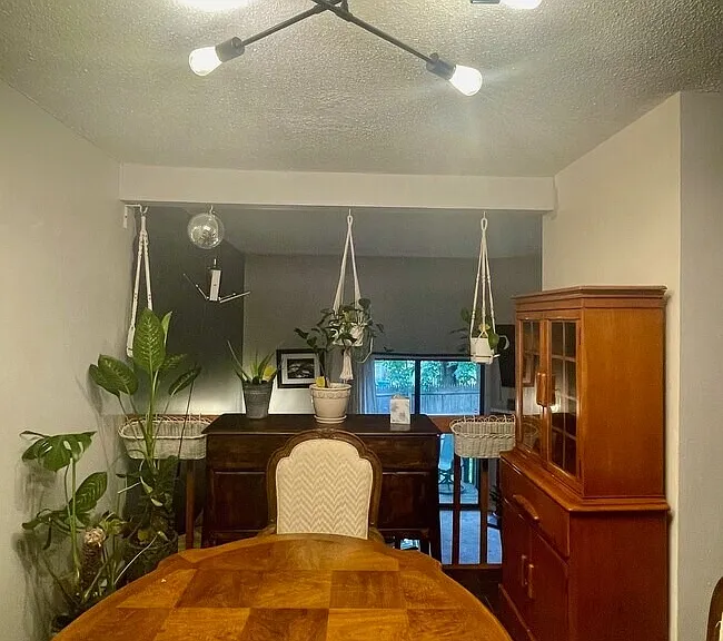Dining or flex area located off kitchen with dark flooring and space for a dining table, desk, or additional living setup.
