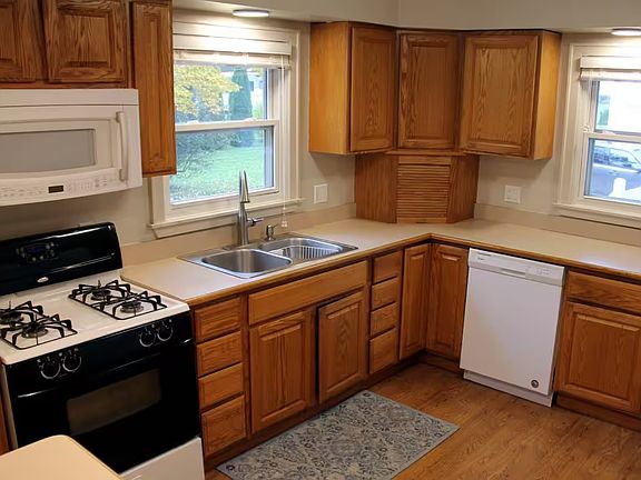 Microwave, Gas Range, Oven, Dishwasher, Coffee Maker, Electric Hot Water Kettle, Stand Mixer and Crockpot. Kitchen is fully stocked with dishes, wine glasses, ice trays, bakeware, and spices.