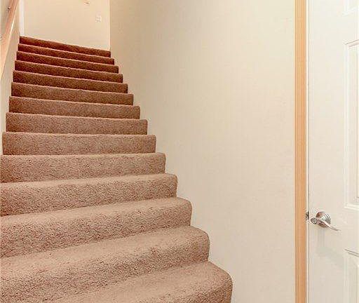 Entry Way; Door to garage on right; upstairs to living space