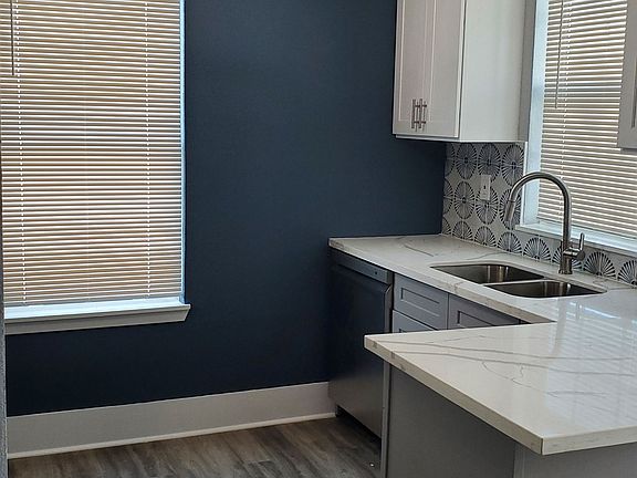 Beautiful natural light pours into the kitchen and peninsula with an overhanging countertop for dining or work