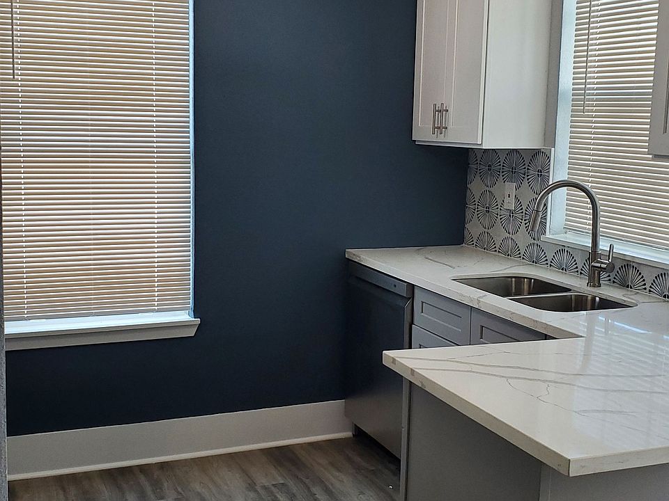 Beautiful natural light pours into the kitchen and peninsula with an overhanging countertop for dining or work