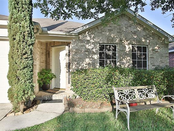 Approaching the front door you'll notice the lovely landscaping, beautiful brick elevation, and covered front porch!