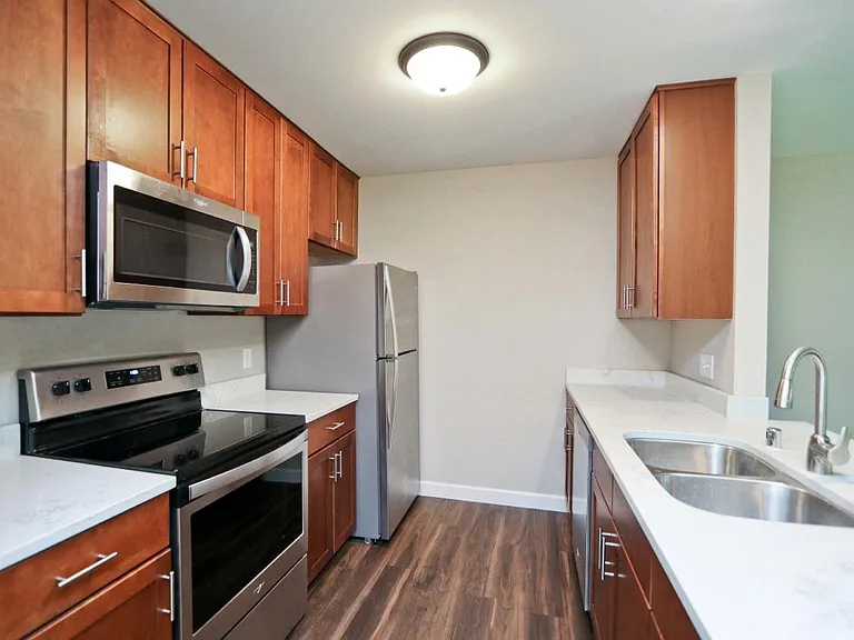 Kitchen features quartz countertops, soft close drawers and stainless steel appliances