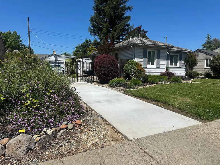 New front driveway to locked gate securing the back half of the driveway and parking area. Also keeps backyard private.