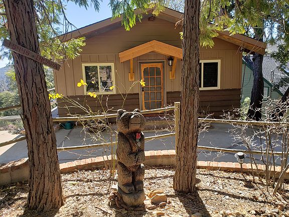 Cute Rustic Cabin with a circular driveway.