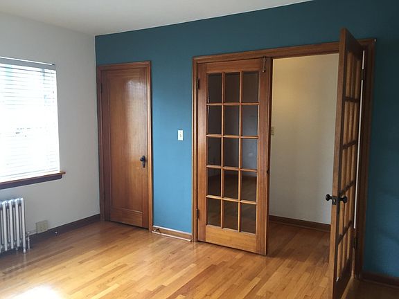 Front bedroom office looking back toward apartment entry. Accent color, and original mahogany doors and trim, shown to good effect here.
