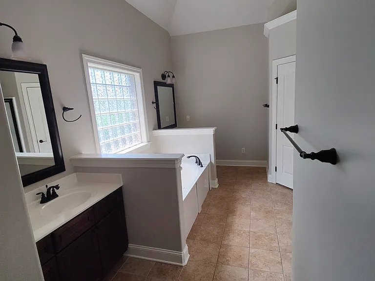 Master bathroom has very high ceiling.