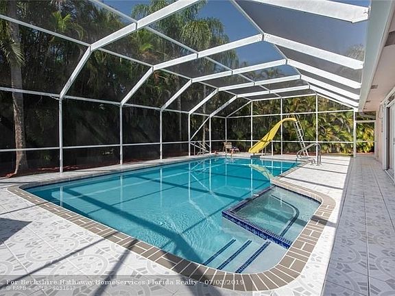 Screened pool with spa & slide for fun for all ages.